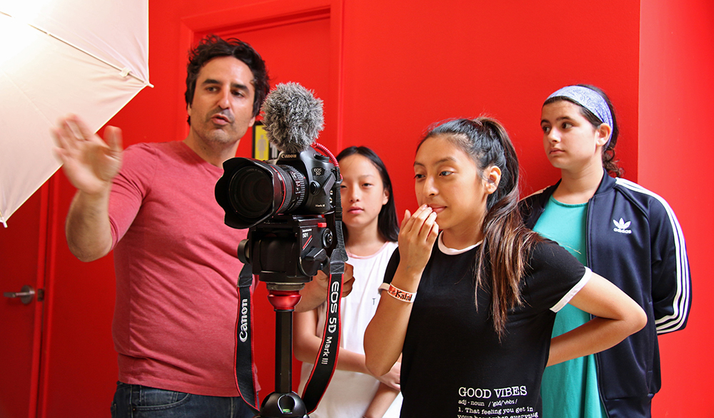 World-renown award-winning filmmaker Raul Barcelona, shown here working with students at One River School's filmmaking camp.